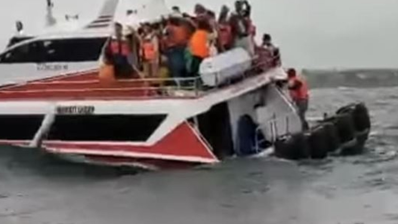 Passengers flee into the water as boat capsizes off the coast of Bali mainland. Picture: Facebook