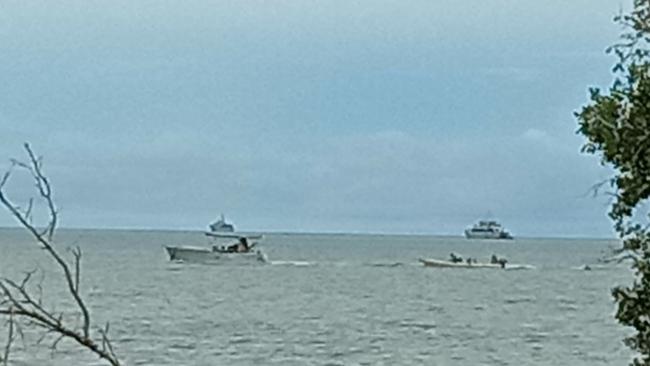 A longboat from Papua New Guinea is towed by Australian Border Force.