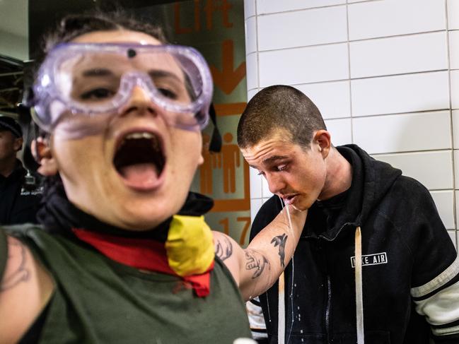 A protester is treated for the effects of pepper spray after police sprayed protesters with pepper spray inside Central Station in Sydney. Picture: AAP