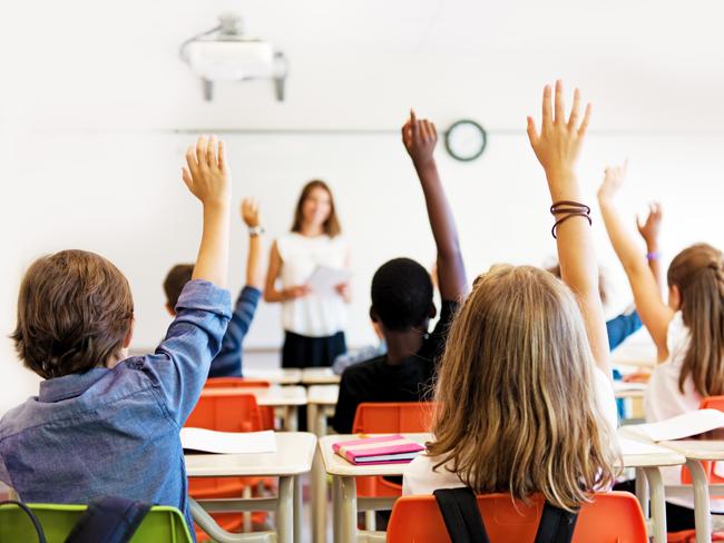 School kids in classroom. Generic (stock) photo of children in a classroom with teacher in background.Picture: iStock