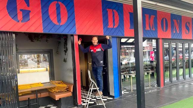 Morris Jones owner Burbank dressed up his closed bar in Demons colours before his ill-fated trip to Perth.