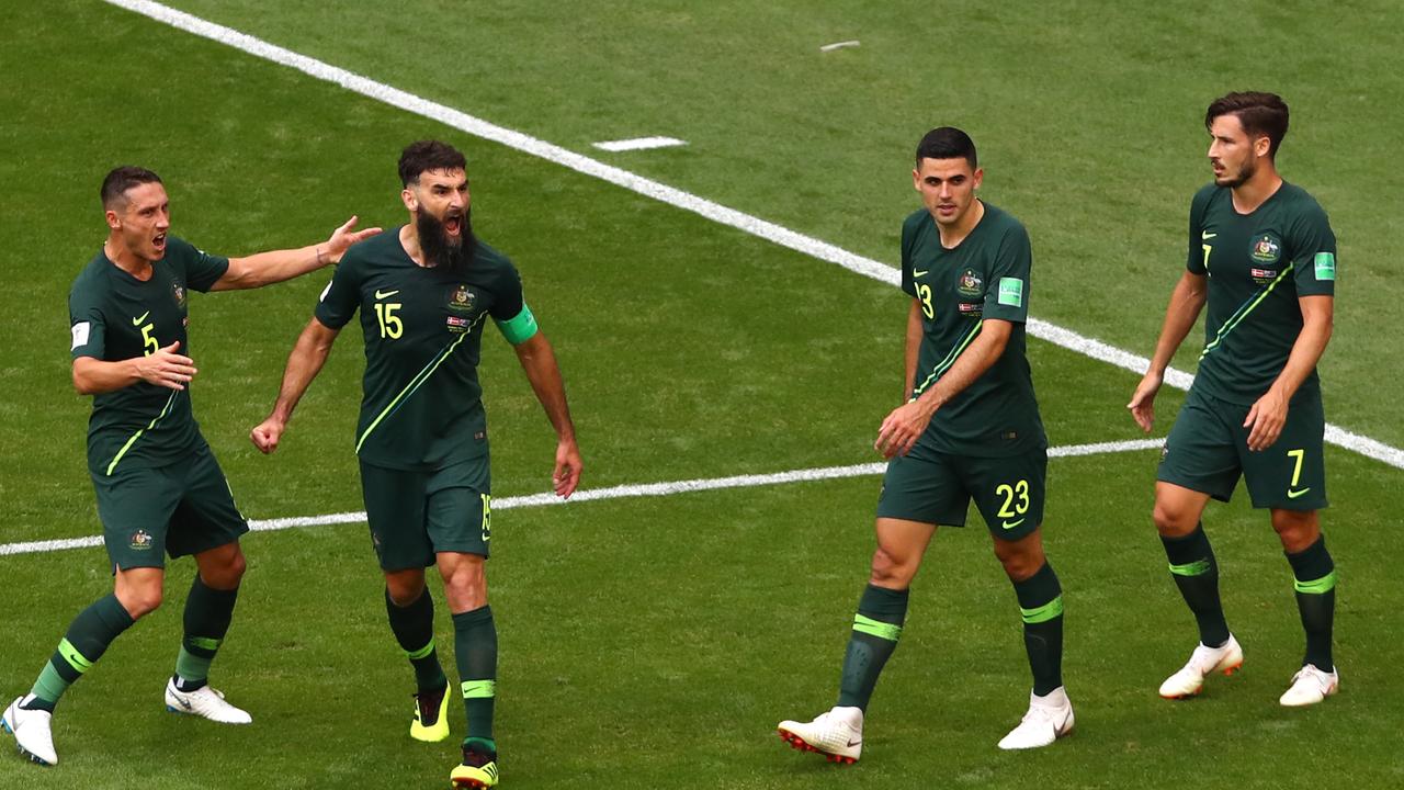 Mile Jedinak celebrates after converting from the penalty spot to draw Australia level against Denmark.