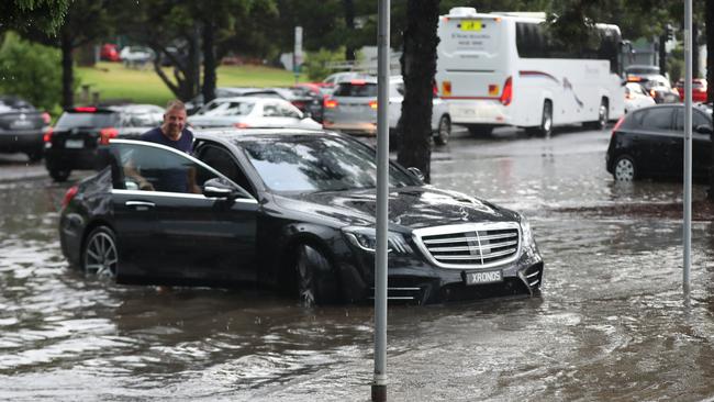 A man’s car caught in the deluge on Geelong. Picture: Alan Barber