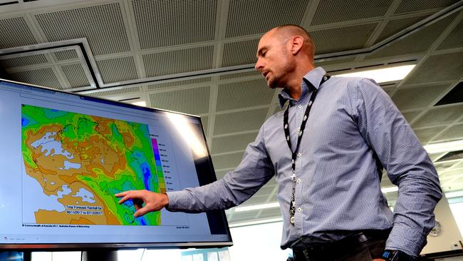 Senior Bureau of Meteorology meteorologist Matt Collopy with charts showing an extreme weather event headed for southern Australia for the first day of summer. Picture: BERNARD HUMPHREYS