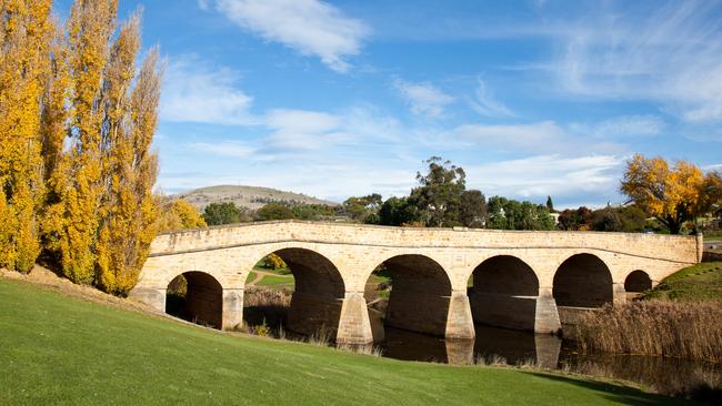 "Richmond Bridge, Tasmania. A heritage listed arch bridge north of Hobart, the oldest bridge still in use in Australia, with blue sky and green grass. It was constructed in 1823 from sandstone using convict labour. Click to see more …" Australia Bridges