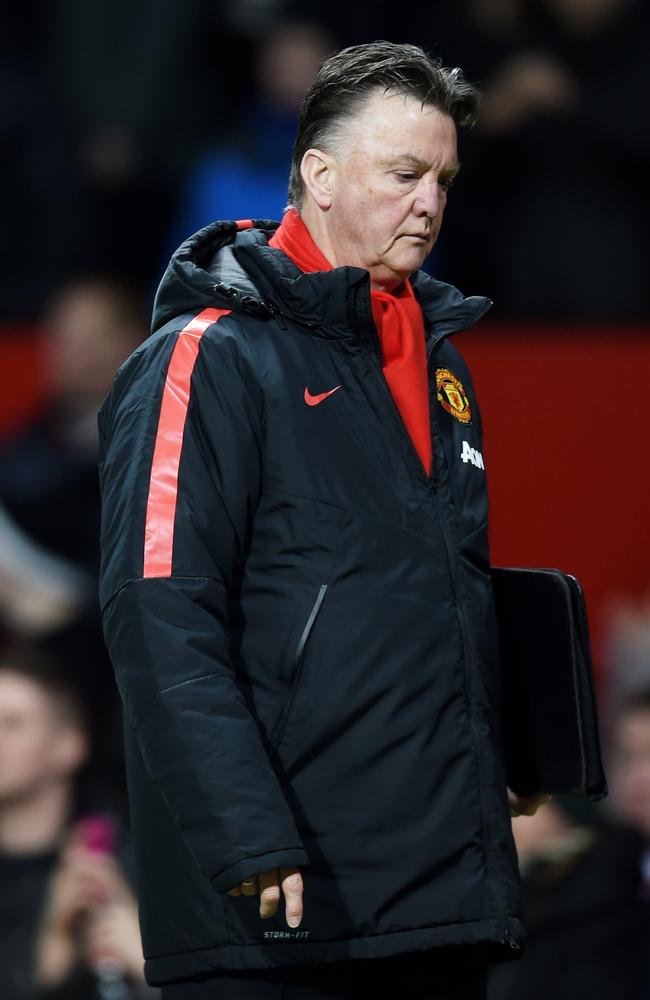 A dejected Louis van Gaal the manager of Manchester United walks off the pitch following his team's 2-1 defeat during the FA Cup Quarter Final match between Manchester United and Arsenal at Old Trafford