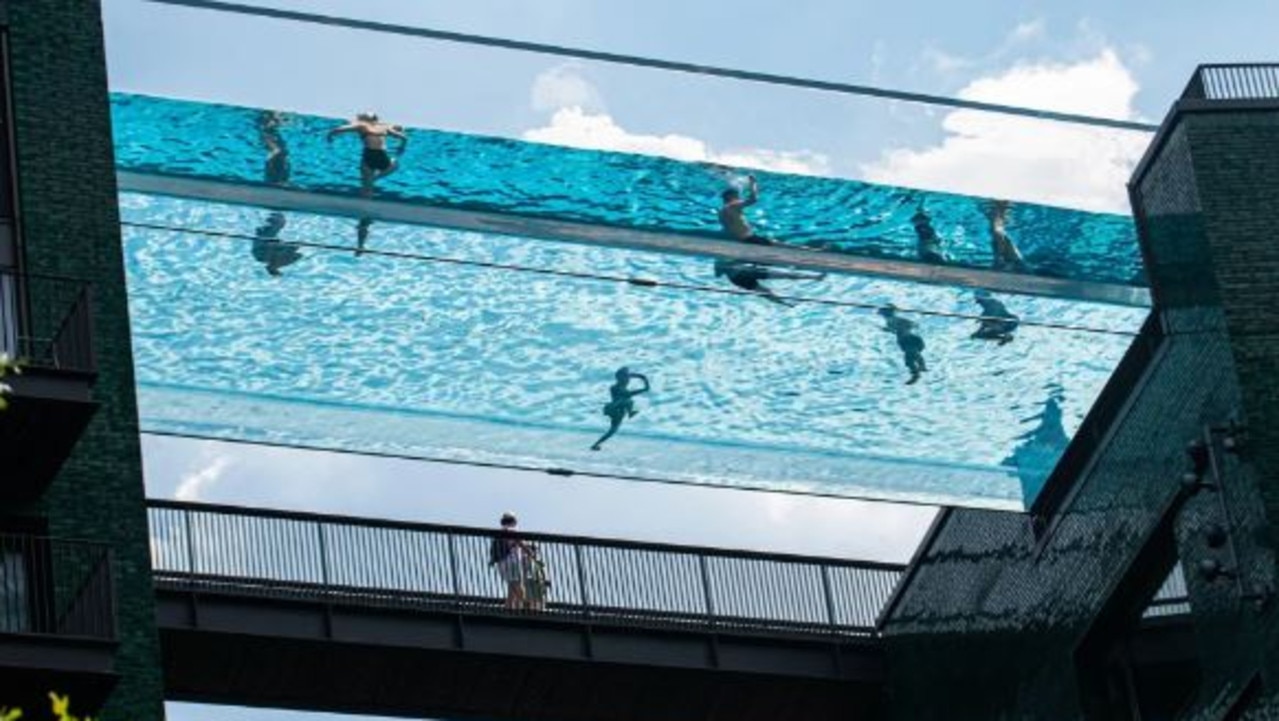 The transparent Sky Pool, suspended 13 floors above the ground between two luxury blocks of flats in London. Credit: The Mega Agency