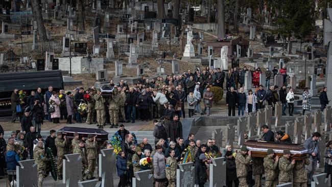 Ukrainian servicemen carry coffins during the funeral service for Oleh Yaschyshyn, Sergiy Melnyk, Rostyslav Romanchuk and Kyrylo Vyshyvany in Lychakivske cemetery on March 15 in Lviv. Picture: Getty