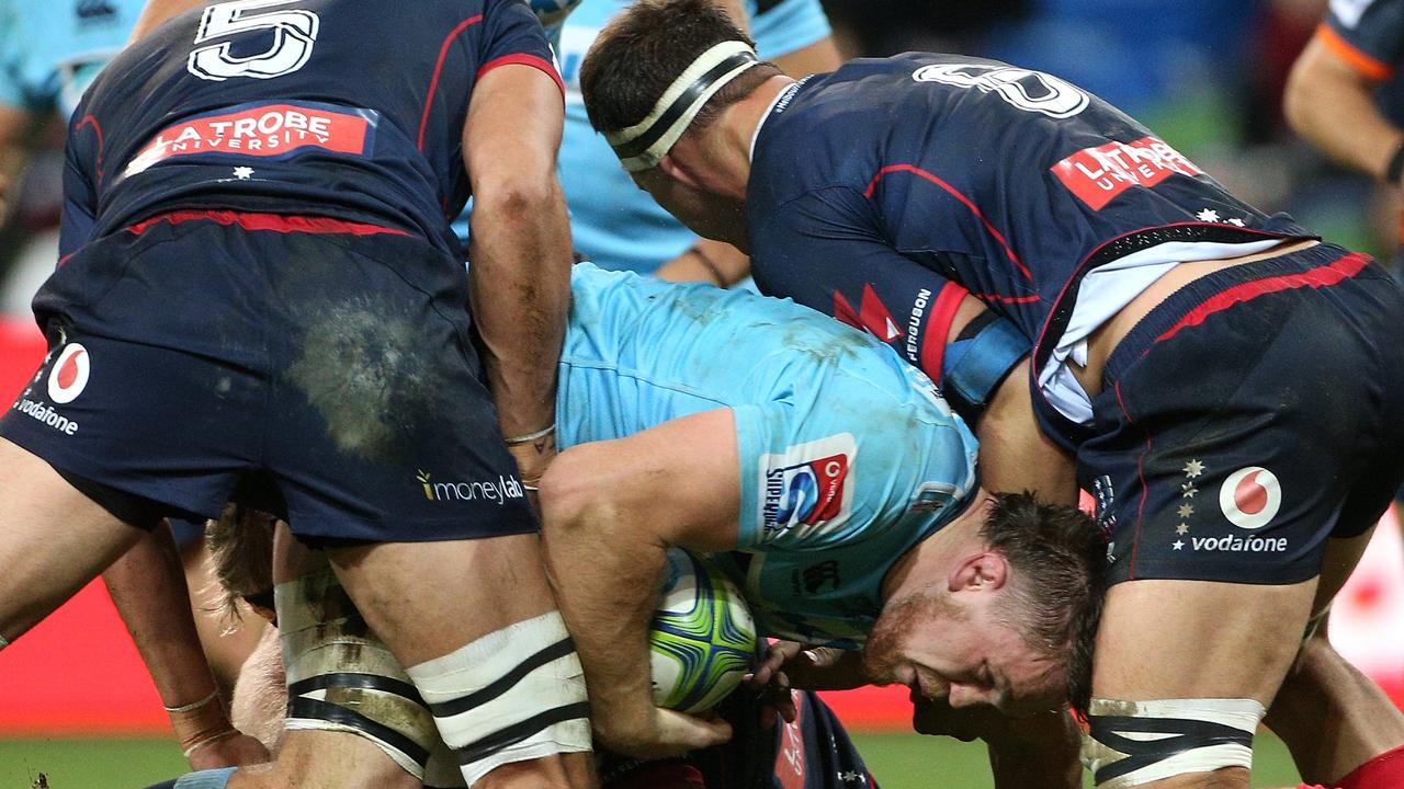 Lachlan Swinton of the Waratahs is tackled at AAMI Park in Melbourne.