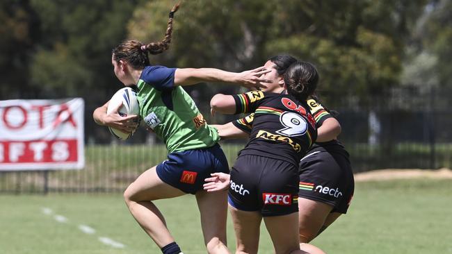 Elise Simpson breaks through the tackle of Montana McLean (#9). CANBERRA, AUSTRALIA, NewsWire Photos. MARCH 9, 2024: Westpac Tarsha Gale Cup - NSWRL Junior Reps Round Six Canberra Raiders vs Penrith Panthers at Raiders Belconnen in Canberra. Picture: NCA NewsWire / Martin Ollman