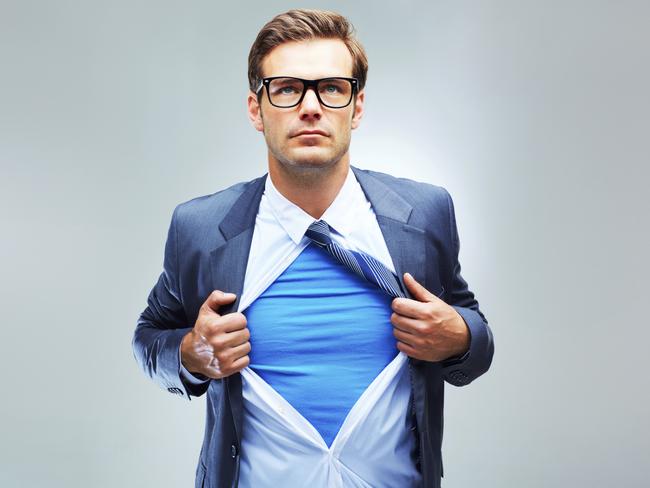 A studio shot of a businessman ripping open his shirt and exposing a costume underneath. Picture: iStock