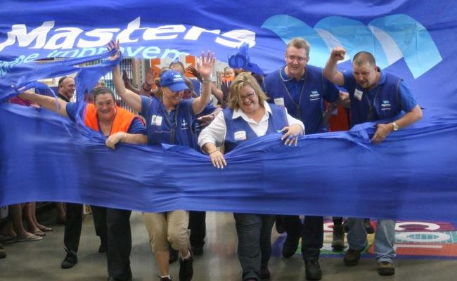 Rockhampton Masters Store manager Kerrie-Anne Barnett leads her staff through a huge banner officially opening the new store. Photo: Chris Ison / The Morning Bulletin. Picture: Chris Ison