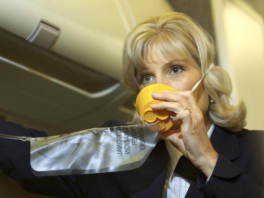 Flight attendant with an oxygen mask