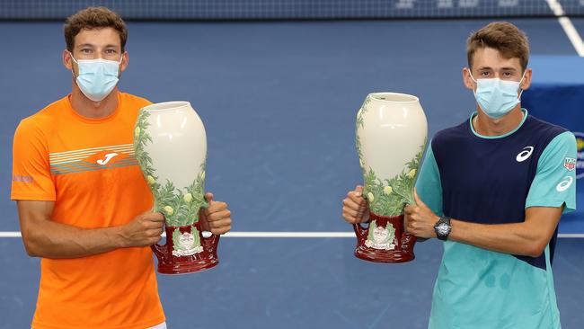 Pablo Carreno Busta, left, and Alex de Minaur pose with their trophies after winning the men’s doubles at the Western &amp; Southern Open in New York. Picture: Getty Images