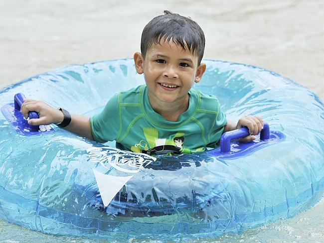 Tristan Cotleanu, five, plays in the wavepool on Darwin Waterfront. Hotel prices in the city jumped 12 per cent last year. 