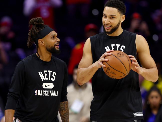 PHILADELPHIA, PENNSYLVANIA - MARCH 10:  Patty Mills #8 and Ben Simmons #10 of the Brooklyn Nets take the court for warm ups before the game against the Philadelphia 76ers at Wells Fargo Center on March 10, 2022 in Philadelphia, Pennsylvania. NOTE TO USER: User expressly acknowledges and agrees that, by downloading and or using this photograph, User is consenting to the terms and conditions of the Getty Images License Agreement. (Photo by Elsa/Getty Images)