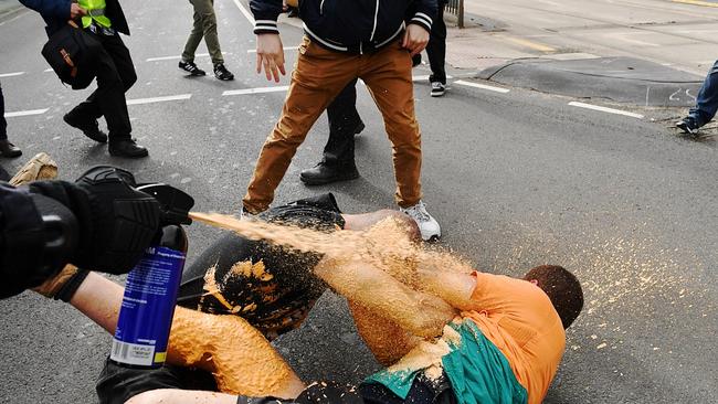 Controversial Alt Right figure MILO YIANNOPOULOS speaks at the Melbourne Pavilion in Flemington. Polce use pepper spray to disperse warring protesters. Picture: Jake Nowakowski