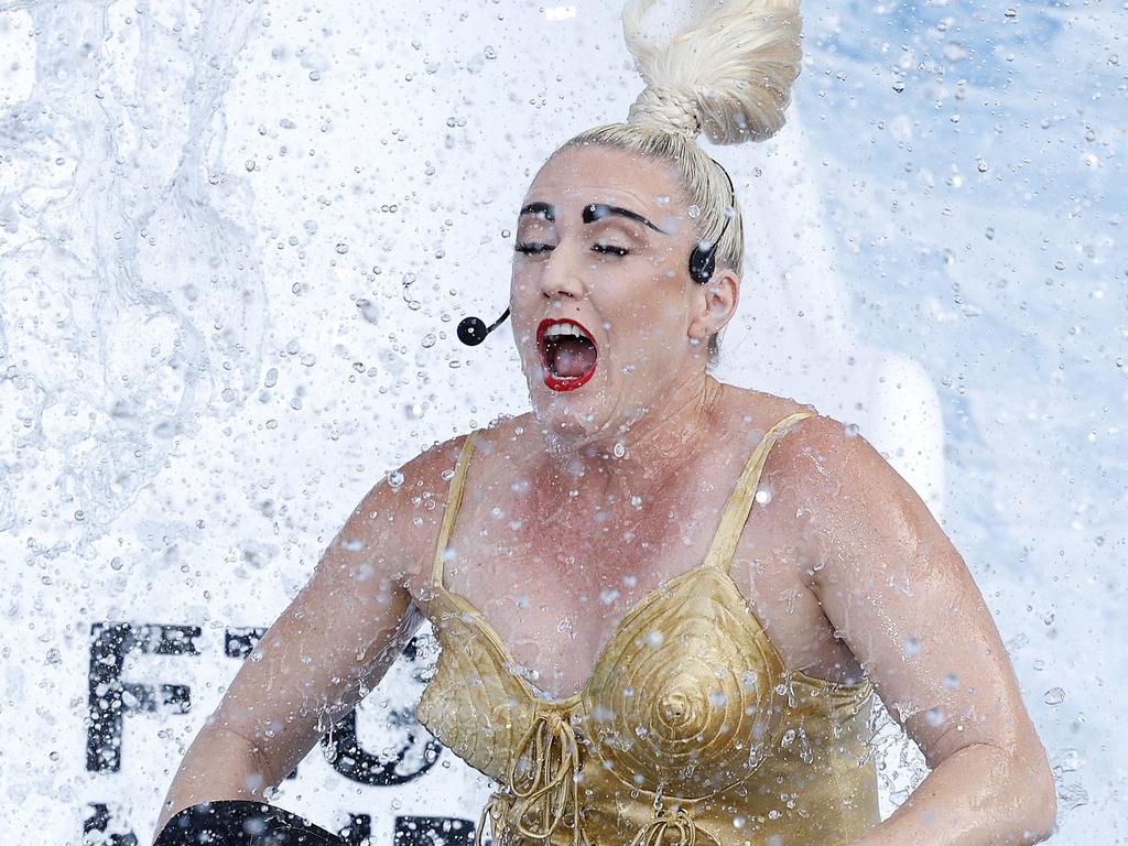 Sally Pearson dressed as Madonna hits the ice slide at the MCG to help raise awareness for the fight against MND. Pic: Michael Klein