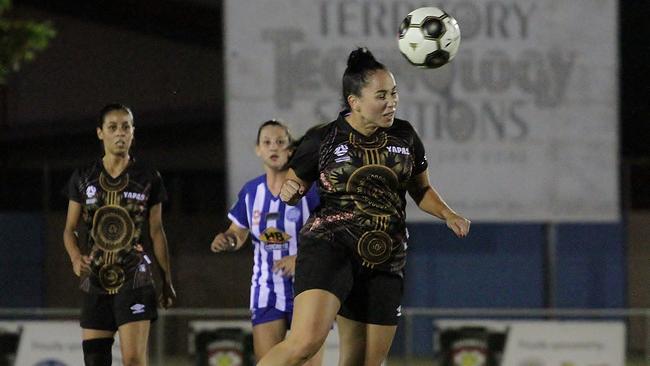 Imogene Briston gets a defensive header away for the NT Yappas. Picture: LOU REEVE