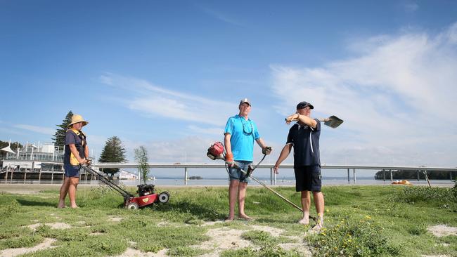 An island formed because of the build up of sand in The Entrance Channel. Councillor Greg Best (centre) and the owners of The Boat Shed pictured in mock up shot of their `working bee’ to mow the grass and plant a tree. (AAP Image/Sue Graham)