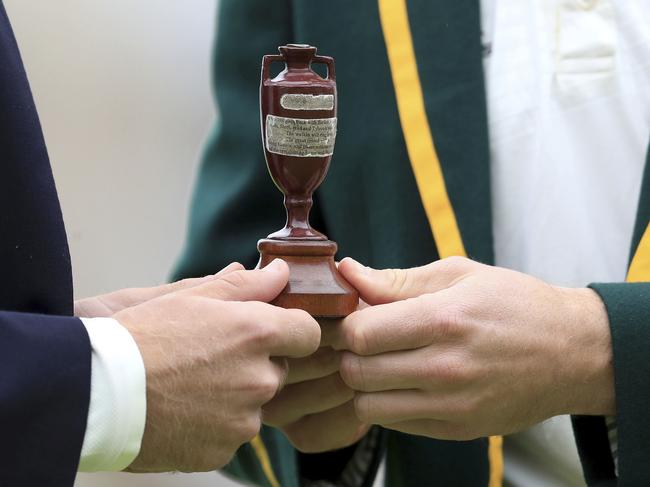 England captain Joe Root, left, and Australia's captain Tim Paine pose with the Ashes urn before the first Ashes Test match between England and Australia at Edgbaston in Birmingham, England, Wednesday July 31, 2019. The first Test match starts Thursday Aug. 1 at Edgbaston. (Mike Egerton/PA via AP)