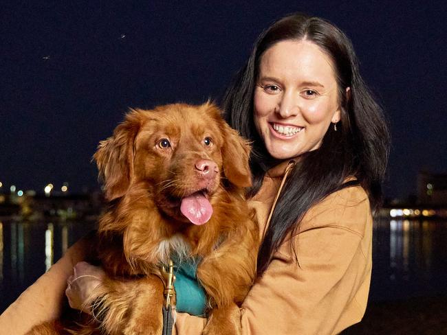 Cassie Schneider with her dog, Juice, 4 at the West Lakes Shore, after attempting to rescue Juice from the lake and then needing to be rescued herself, Monday, Sept. 11, 2023. Picture: Matt Loxton