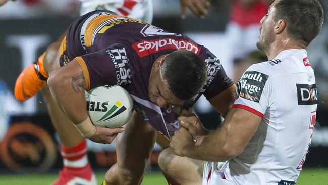 Broncos halfback Kodi Nikorima is tackled by Dragons opposite Ben Hunt.