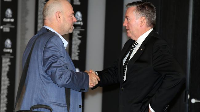 Mark Robinson shakes hands with Collingwood president Eddie McGuire. Picture: Michael Klein