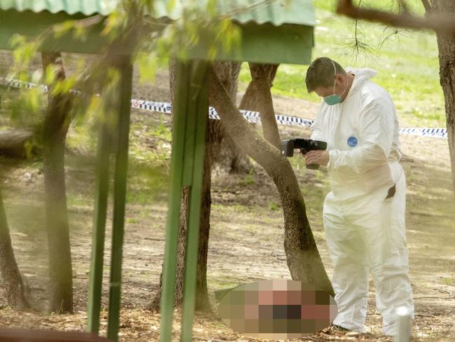 The body of a woman found at Buffalo Creek reserve is photographed by a forensic officer at a playground at Hunters Hill Pic Jenny Evans