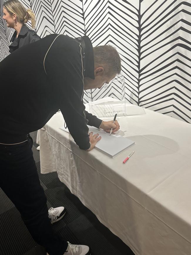 British comedian David Walliams writing a message in a birthday guest book. Picture: Supplied.