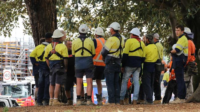 A crane collapsed today at the construction site of the Sydney Fish Markets. Evacuated workers watch on. Picture: NCA NewsWire / Max Mason-Hubers