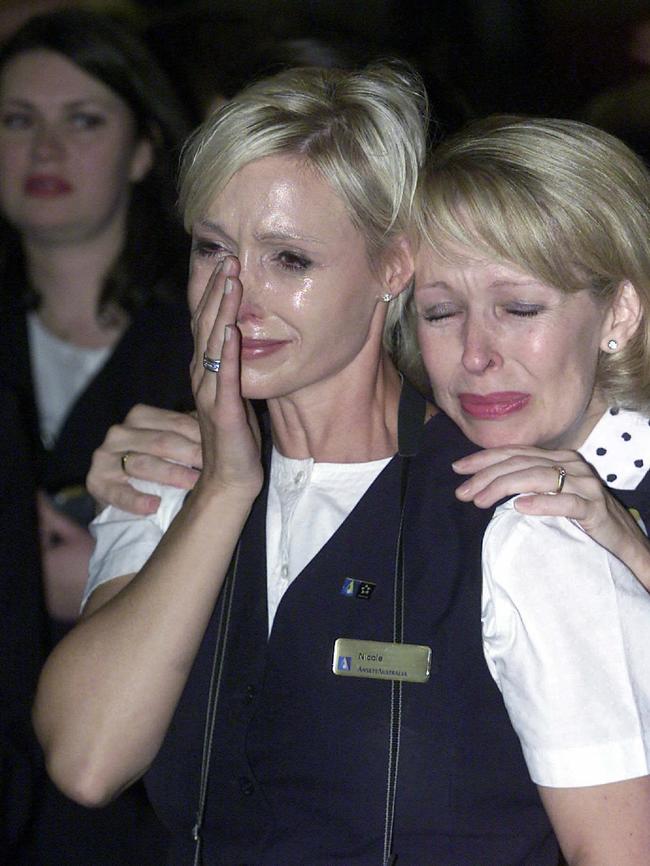 Jenny Pert (right) consoles Nicole Liddell as the last Ansett flight leaves Melbourne. Picture: Colin Murty