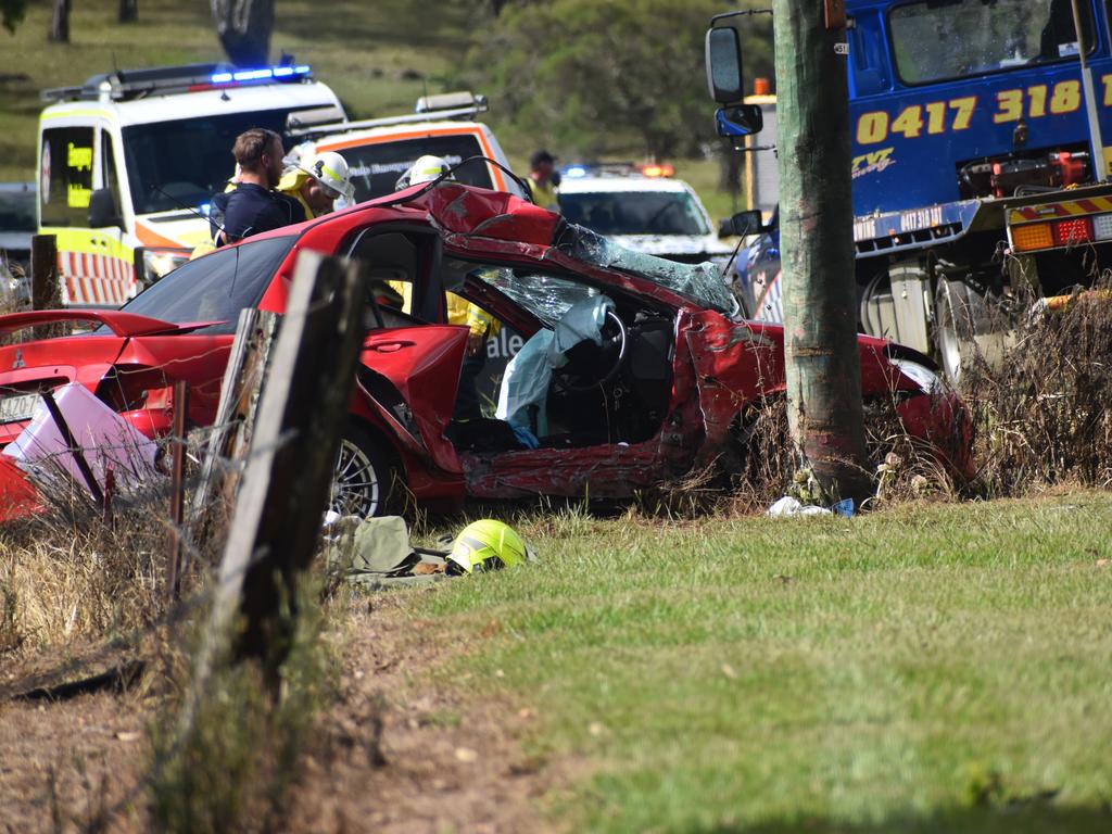 Multiple emergency services crews attended after a red sedan Mitsubishi Lancer sedan crashed into a power pole on Rogans Bridge Rd north of Waterview Heights on Thursday, 18th February, 2021. Photo Bill North / The Daily Examiner