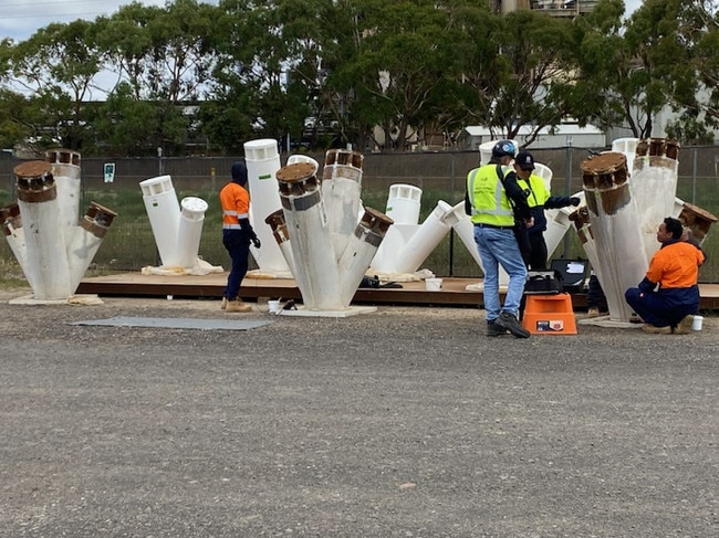 Workers inspecting steel imported for Qatar that is meant to be used in the new stand at GMHBA Stadium.