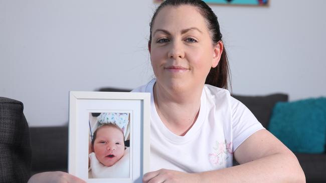 Ocean Grove mum Candice Bigham with a picture of her daughter Billie who died from enterovirus in 2019. Picture: Alan Barber