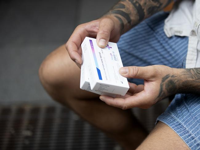 SYDNEY, AUSTRALIA - NewsWire Photos JANUARY 13, 2022: A customer holds his (RAT) rapid antigen tests after purchasing them from a chemist in Sydney. The RATs are used to self test for covid-19. Australians are dealing with low supplies following the surge in COVID cases across the country. Picture: NCA NewsWire / Nikki Short