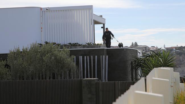 A police sniffer dog at the home of John Ibrahim. Picture: John Grainger