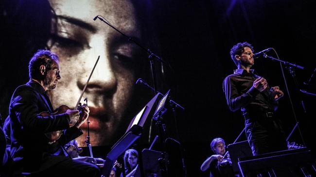 A Bill Henson photograph looms over Richard Tognetti (left) and singer Lior as the Australian Chamber Orchestra perform Luminous. Picture: Julian Kingma