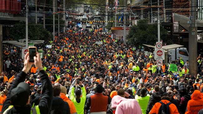 Construction workers march through the streets yesterday in Melbourne.