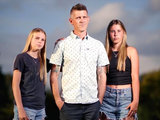 #MUST HOLD#- Lee Lovell with daughters, L to R, Kassie 14yrs, Scarlett 16yrs - Lee Lovell's wife Emma Lovell was murdered during a home invasion a year ago, at home in North Lakes, on Monday 11th December 2023 - Photo Steve Pohlner