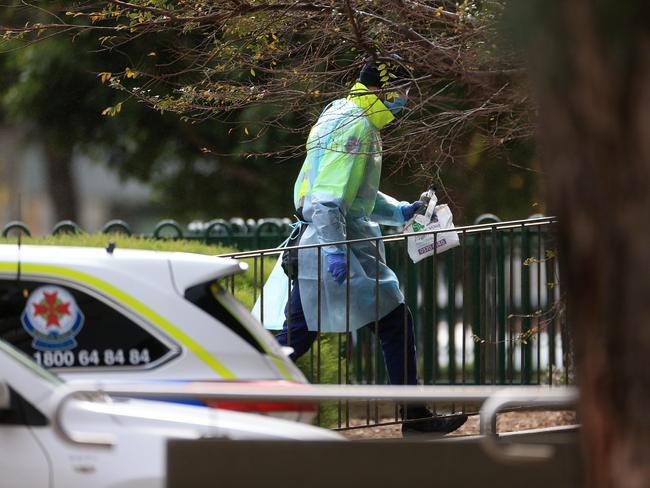 Police block off all entry ways to the housing commission towers on Flemington Rd and Holland Crt. Private security in full PPE enters 120 Flemington Rd. tower. Picture: Sarah Matray