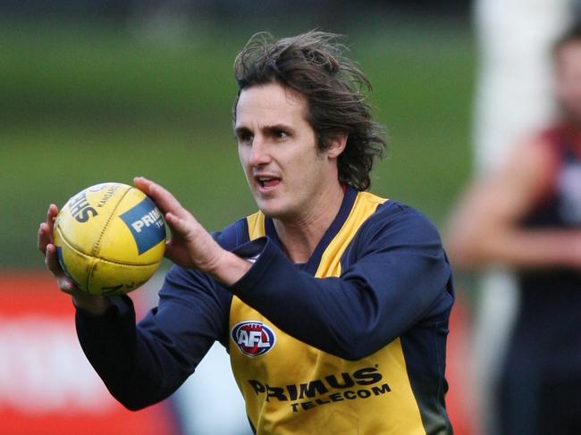 Melbourne football training. Travis Johnstone accepts the ball on the run.