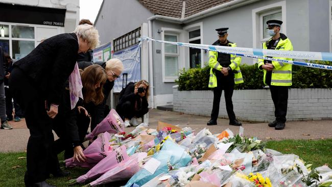 Well-wishers lay floral tributes at the scene of the fatal stabbing of Conservative British politician David Amess, at Belfairs Methodist Church in Leigh-on-Sea. Picture: AFP