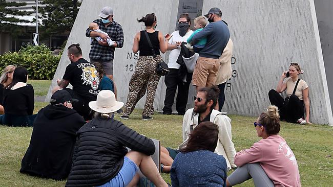 Pictures of families doing Father’s Day over the border barriers at Coolangatta. Picture by Richard Gosling