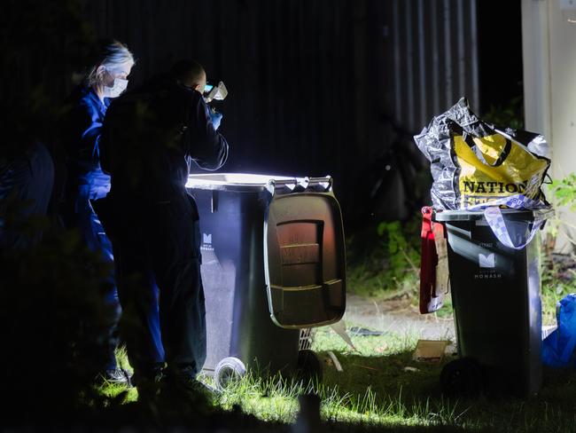 Missing Persons Squad detectives and forensics at a crime scene along Railway Parade Chadstone and also at a property on Binalong Avenue, Chadstone. Police look through a garbage bin. Picture: Jason Edwards