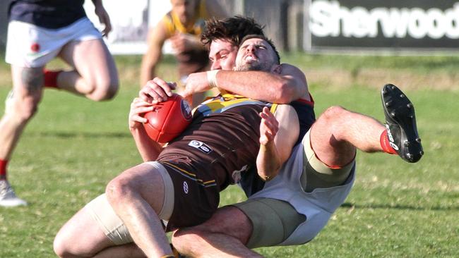 Thomastown Anthony Capeci cops a coat hanger from a Diamond Creek opponent during their Northern Football League match. Picture: Aaron Cook.