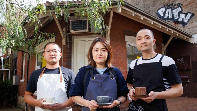 Cafe owners Michael Chen, Angela Chung and Daen Xu standing in front of the proposed coffee shop. Picture: David Swift