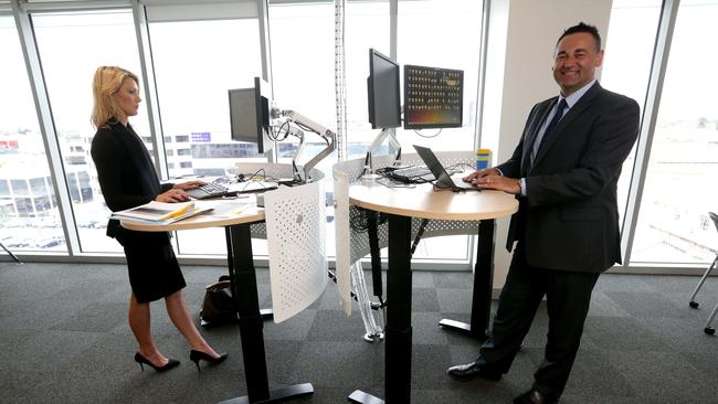 State manager Con Tragakis at a stand-up desk at the Adelaide office.