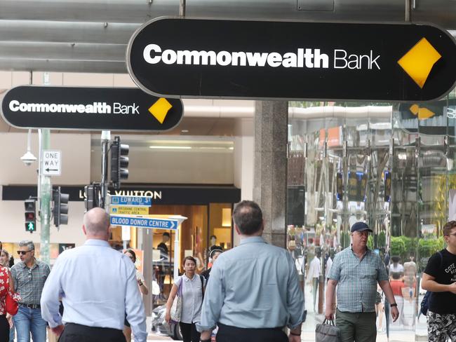 Generic photos the outside close up of logos people using the cash machine and walking past signage of the Commonwealth Bank. Pic Annette Dew