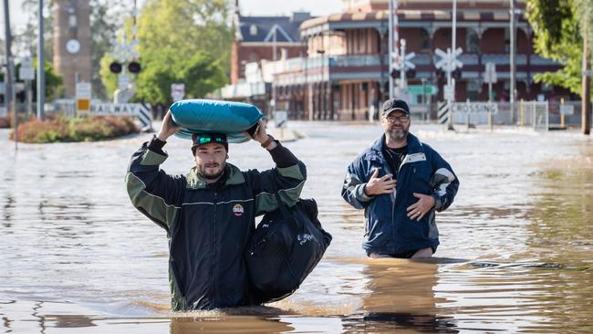 Rochester residents wade through floodwaters. Picture: Jason Edwards